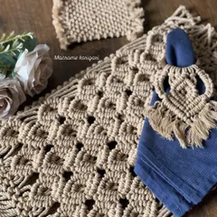 Elevate your dining experience with our macramé table decor set. This collection, featuring a detailed placemat, coaster, and fringed napkin ring, adds a touch of handcrafted elegance to any meal.