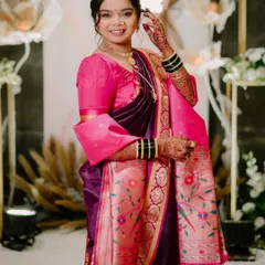 The full view of the bride's 'Vidhi' look. The vibrant purple and pink Paithani saree is complemented by a soft, glowing makeup application that looks effortlessly beautiful.