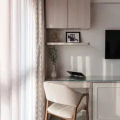 A perfect example of a multi-functional bedroom. This calm corner features a study desk seamlessly blended into the TV unit, creating a peaceful and productive workspace without disrupting the room's restful energy.