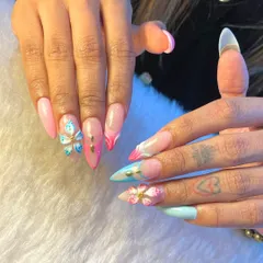 This look is all about being the main character. We created this set with long acrylic extensions, a soft pastel pink and blue base, and delicate 3D floral and butterfly accents for a touch of whimsy.