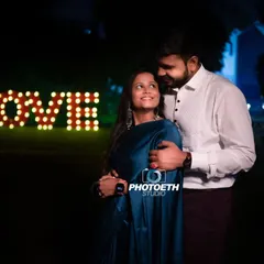 A simple yet powerful pre-wedding photo using an illuminated "LOVE" sign. The soft lighting creates an intimate and romantic mood.