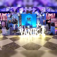 A detailed and immersive "Boss Baby" stage, with multiple backdrops, character cutouts, and themed props creating a dynamic and fun environment for a first birthday.