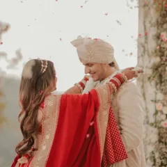 We designed this elegant off-white sherwani for YouTuber Nischay Malhan's wedding. The subtle texture and clean lines create a sophisticated and regal look, complete with a matching safa and stole.