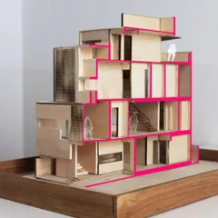 A sectional model of the LUCID House, made from balsa wood. This model was crucial for studying the interplay of volumes, the triple-height light well, and the circulation paths within the home.