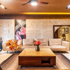 I love bringing a client's personality into their home. This living room combines earthy tones and natural textures with a pop of color from the flamingo mosaic art. The result is a warm, inviting space that is full of character.