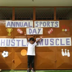 Arms raised in triumph. This little Aster is thrilled to be a part of our Annual Sports Day, an event where every child gets to experience the fun of friendly competition and physical challenges.