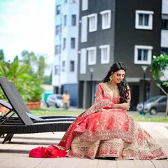 Our model relaxing by the poolside in the bridal lehenga, showing its versatility for different photo opportunities on your special day.