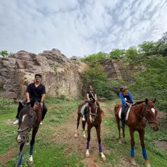 A group of friends enjoying their ride together against the backdrop of the rocky Aravali terrain. Our safaris are a great way to bond and share a unique outdoor adventure.