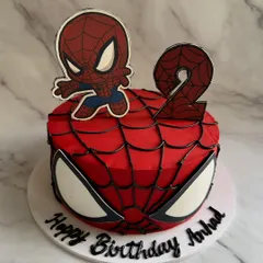 Your friendly neighborhood Spider-Man, in cake form! This design captures the iconic superhero with a web-covered red base, big spider eyes, and a cute chibi-style topper for a 2nd birthday.