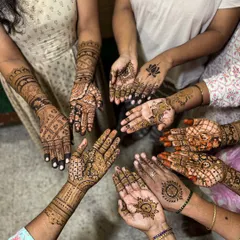 A beautiful moment with the bride's family and friends. We love creating a festive atmosphere where everyone gets a unique design, showcasing our team's ability to handle large groups efficiently.