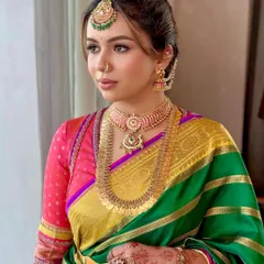 The quiet grace of a South Indian bride. This profile captures the serene beauty of Deeksha, with makeup that enhances her features while honoring the sanctity of the Muhurtham ceremony. It's a look that feels both classic and contemporary.