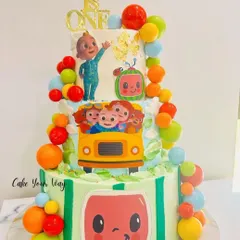 The wheels on the bus go round and round on this fun Cocomelon cake. This three-tier creation is perfect for a first birthday, featuring all the beloved characters and bright, happy colors.
