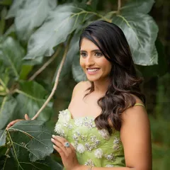 This shot captures a beautiful, candid smile. The natural environment provides a serene and organic backdrop for a relaxed portrait session.