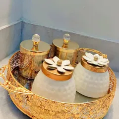 A showcase of some of the beautiful, reusable jars I use in my hampers. This set includes four decorative jars on a mirrored, filigree gold tray, perfect for adding a touch of elegance to any home.