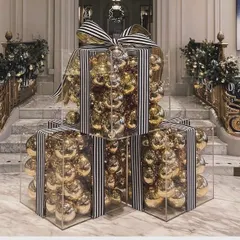 At Balloon World, even Christmas decor isn't simple. These giant, clear gift boxes filled with gold ornaments and tied with striped bows make for a stunning and modern holiday installation.