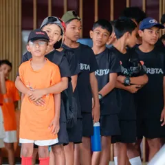 A group of our young, aspiring players, focused and ready for their next drill. We aim to build not just tennis skills, but also character, teamwork, and the mental fortitude of a champion.