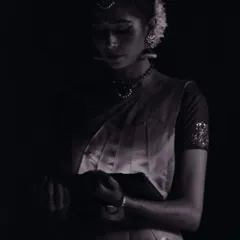 A quiet, contemplative moment captured in the wings, just before stepping onto the stage. The moments before showtime are filled with focus and anticipation.