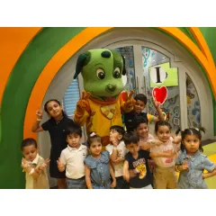 A group of friends, big and small, huddle together with Tinga Dojo for a fun and silly picture.