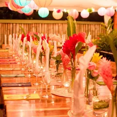 A long table set for a traditional Sajjan Koth dinner, decorated with tropical flowers and colorful paper lanterns. We take great pride in arranging this important pre-wedding ceremony with the respect and lavishness it deserves.
