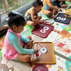 Even our crafts were pool-themed! Here, the children are painting donut-shaped floaties, getting creative before heading to the pool for a splash.