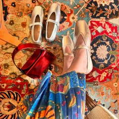 A vibrant, festive scene featuring my metallic silver ballet flats and a bright red bag. This image captures the celebratory spirit of the season and the versatility of a great metallic shoe.