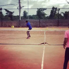A player practices his net game, executing a jump volley. My advanced training covers all areas of the court, including aggressive play at the net.