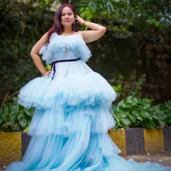 Feel like you're floating on a cloud in this dreamy, light blue tiered ruffle gown. The layers of tulle create incredible volume and movement.