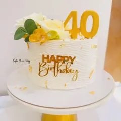 Classy and celebrated. 40 never looked better than on this elegant white cake with gold leaf accents.