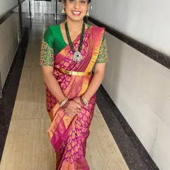 A full-length shot of the guest, looking graceful and elegant in her silk saree and perfectly styled hair.