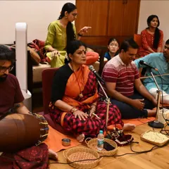 A rehearsal session with the full music ensemble. I am conducting the nattuvangam, guiding the musicians and dancers to ensure perfect harmony.