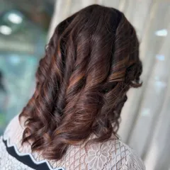Another angle of these beautiful curls. The styling is designed to hold its shape while still having soft movement and bounce.