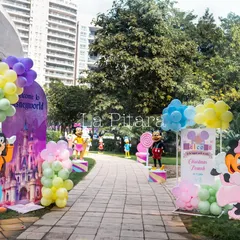 The walkway into the Disney-themed party, lined with colorful balloon displays and life-sized cutouts of beloved characters like Goofy and Minnie Mouse, creating a joyful and exciting entrance path.
