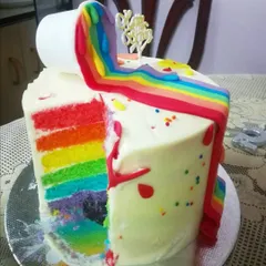 Here's a look inside the artist cake, revealing the vibrant rainbow layers. Each slice is a burst of color, making the cake as beautiful on the inside as it is on the outside.