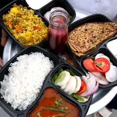 A glimpse of the variety I offer in my daily tiffin service. Here you can see a complete Veg Pulav meal, a comforting Rajma Chawal combo with fresh salad, and a hearty Paratha thali, all packed hygienically and ready to enjoy.