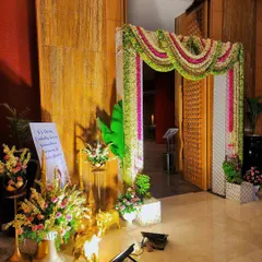 A beautiful entrance decoration for a baby shower, featuring a welcome sign and floral arrangements.