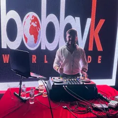 My office is the stage. Here I am at my console with my 'Bobby K Worldwide' logo in the background, ready to take my music anywhere.
