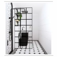 A view into the shower area, separated by a black-framed glass partition that adds an industrial-chic touch.