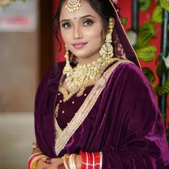 A beautiful portrait of a North Indian bride. Her makeup is kept soft and elegant to balance the heavy gold jewelry and the rich embroidery of her outfit.