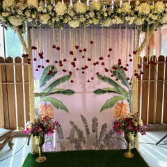 For a more traditional Godh Bharai, we designed this beautiful backdrop featuring banana leaf prints and hanging floral strings. The setup is framed with fragrant white flowers, creating a serene and auspicious setting for the ceremony.