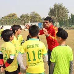 Coaching at Kick FC is about more than just drills. It's about mentorship, strategy, and building a cohesive team. Here, one of our coaches discusses tactics with the youth team during a break in a league match, ensuring they understand the game and their role in it.