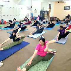 Students exploring deep hamstring and hip stretches. I provide modifications for every pose, ensuring that each person can access the benefits regardless of their current flexibility. This is a typical scene from our flexibility focused sessions.