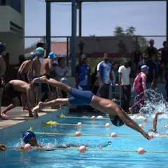 The moment of launch. Our swimmers practice race starts relentlessly, learning to explode off the blocks with perfect form to gain an immediate advantage in the water.