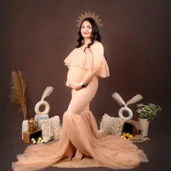 This is an example of my earthy, boho-themed maternity session. The warm brown backdrop, macrame details, and a sun-like crown create a natural and regal portrait, celebrating the queen that you are.