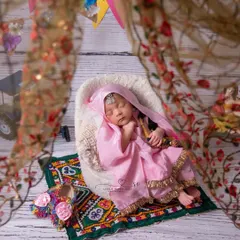 Here is our "choti si punjaban aur uska swag!" I love celebrating regional cultures, and this traditional Punjabi suit, complete with a phulkari-style mat and tiny jutti, makes for an incredibly vibrant and personal portrait.