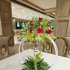Another view of the table centerpiece, this time with red roses. These arrangements add a touch of elegance to the guest seating area.