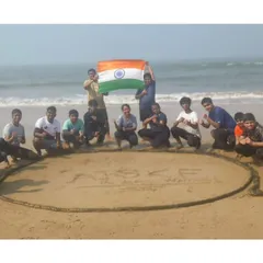 Our mark of pride in the sand. The team gathers around the AISKF name after a tough outdoor training session, showing the camaraderie and shared accomplishment that defines our bootcamps.