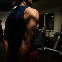 This photo was taken on day four of a client's lean bulking journey, focusing on triceps. The visible muscle definition in his arm is a direct result of our targeted triceps workout and nutrition plan.