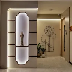 Ready to make a grand entrance? This hallway features a backlit niche for displaying art, modern wall art of Ganesha, and sleek, handle-less storage, blending spirituality with contemporary design.