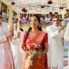 The pure joy of a bride on her wedding day. Her red Kanjeevaram, which I had the honor of pre-pleating, moves beautifully with her as she walks under the floral canopy.