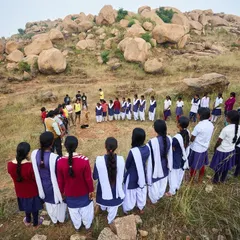 The girls gathered in a circle for a quick introduction to bouldering and safety. Despite being shy at first, their excitement grew with every climb.